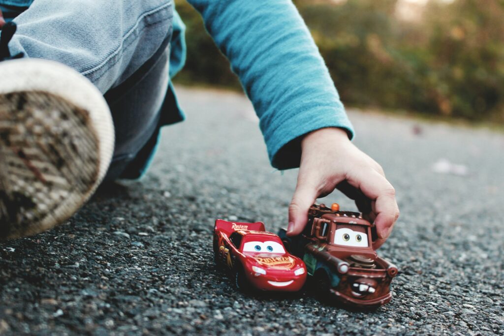 Child playing with cars, mobile speech therapy